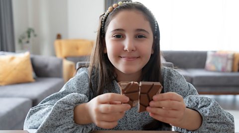 Child eating a chocolate bar.