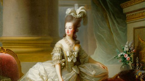 A portrait of Marie Antoinette from the late 1770s. It shows her from a distance, wearing an elaborate court dress with a large feather headdress. She is gazing off to the left. 