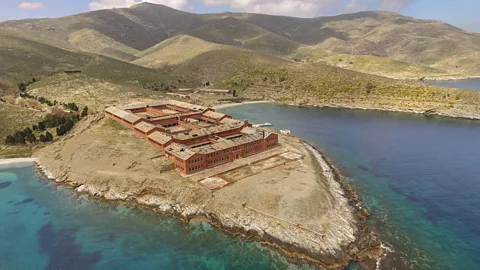 George Stefanou /WWF Greece The abandoned prison on Gyaros – a large red brick structure on a peninsula surrounded by blue green waters (Credit: George Stefanou /WWF Greece)