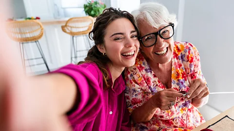 Alamy A young person's hand holds an older person's hand (Credit: Alamy)
