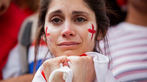 Female England fan looks disappointed at yet another tournament exit.
