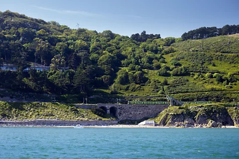 Getty Images At Killiney, the Dart runs within metres of the Irish Sea, threading between the shoreline and wooded hills (Credit: Getty Images)