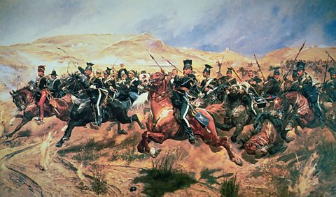 Painting of cavalry soldiers charging on horseback across a battlefield, with raised sabres and lances, dust and smoke, fallen horses, and dry hills beneath a stormy sky.