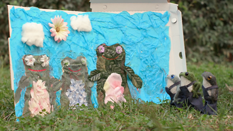 Toy frogs, admiring their craft mural.