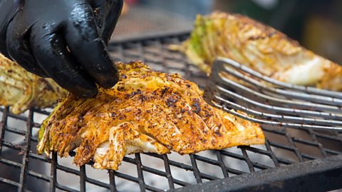 An image of someone grilling cabbage on a barbecue 