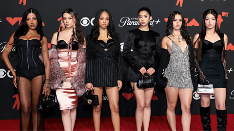 Katseye members Lara, Megan, Manon, Sophia, Daniela and Yoonchae on a red carpet. 