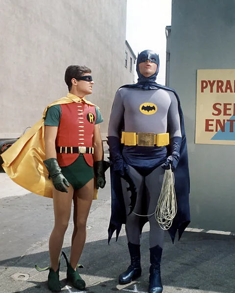 Getty Images Before The Dark Knight Rises, the average person saw Batman as Adam West in the self-mocking, camp 1960s comedy TV series and film (Credit: Getty Images)