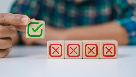 Four blocks with red crosses on with one block with a green tick on.