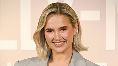 Molly-Mae smiling to camera at a launch event.