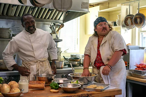 A24 Restaurant staff like Tyrone and Dimitri are depicted in the film – but with less pivotal roles than in Kitchen Confidential (Credit: A24)