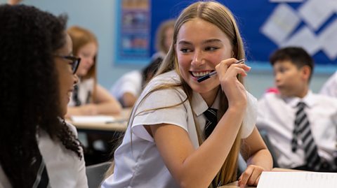 teenage girls chat in class