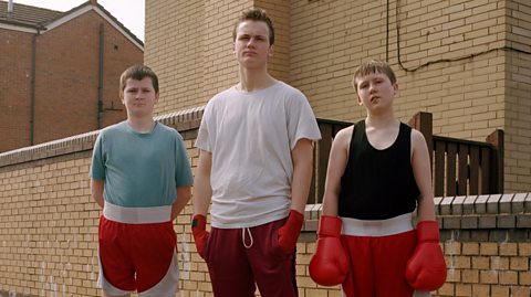 siblings and friend in boxing gloves on a Manchester street
