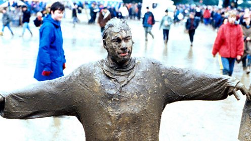 A Glastonbury festival goer covered in mud 1997