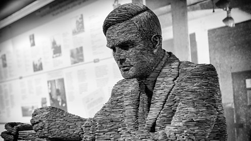 Slate statue of Mathematician Alan Turing at Bletchley Park - shutterstock_436299130