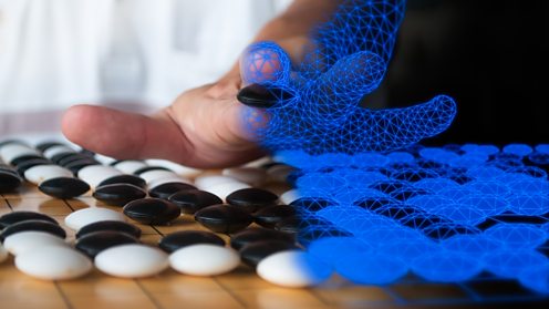 Human hand playing Go game with virtual hand overlay