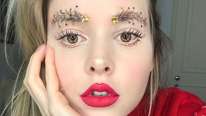 A girl with eyebrows decorated like Christmas trees