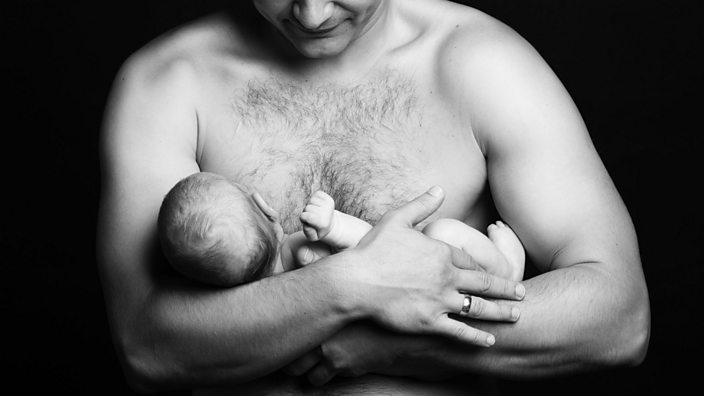 Man store breastfeeding baby