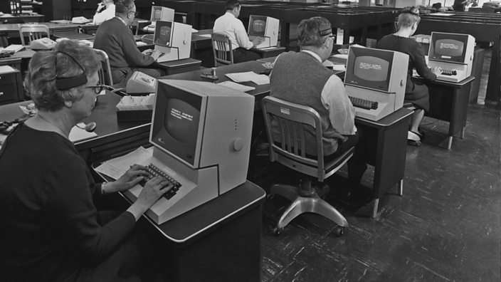 Office workers using computers in 1965