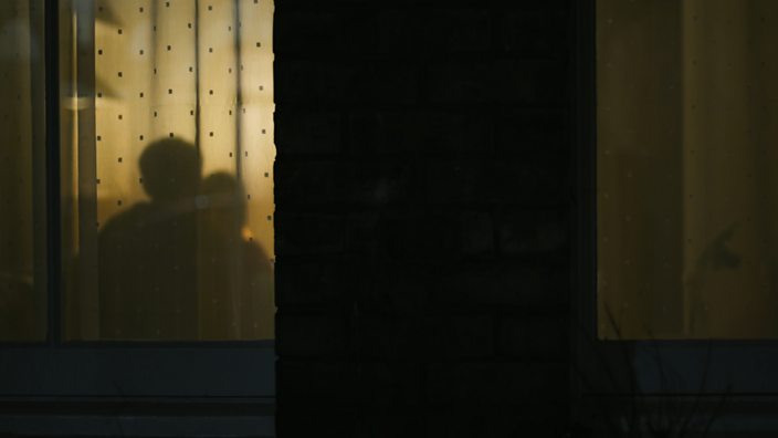 A still from the abused by my girlfriend documentary showing shadows of a couple through window