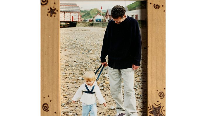 Alex and her dad, when she was little, walking on the beach.