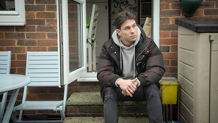 Joey Essex sat on a step thinking.