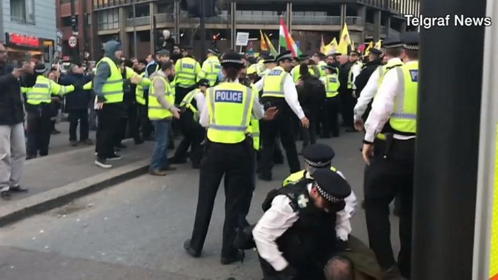 Police watchdog reviews 'officer punching protester' video - BBC News