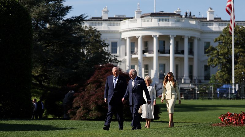 The Queen, King, Donald and Melania Trump converse as they walk outside the White House through the garden on Monday.