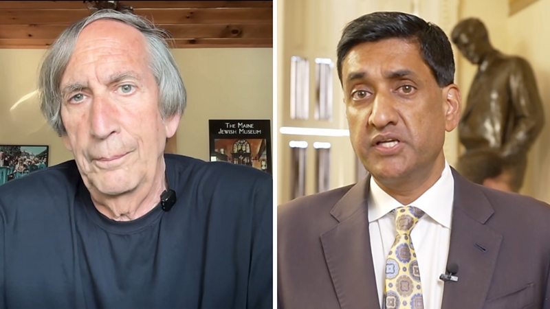 A grey haired man in a t-shirt on the left and a man in a suit and tie on the right.