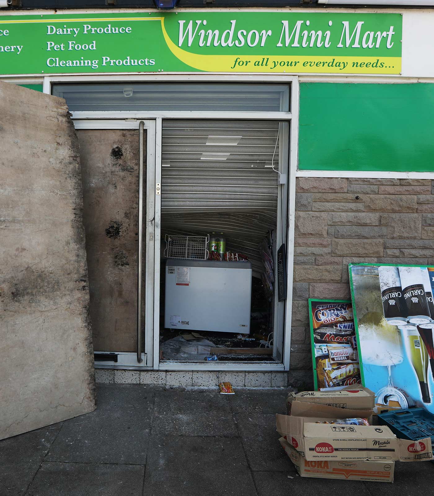 The outside of the Windsor Mini Mart after it was damaged by rioters - 31 July 2024