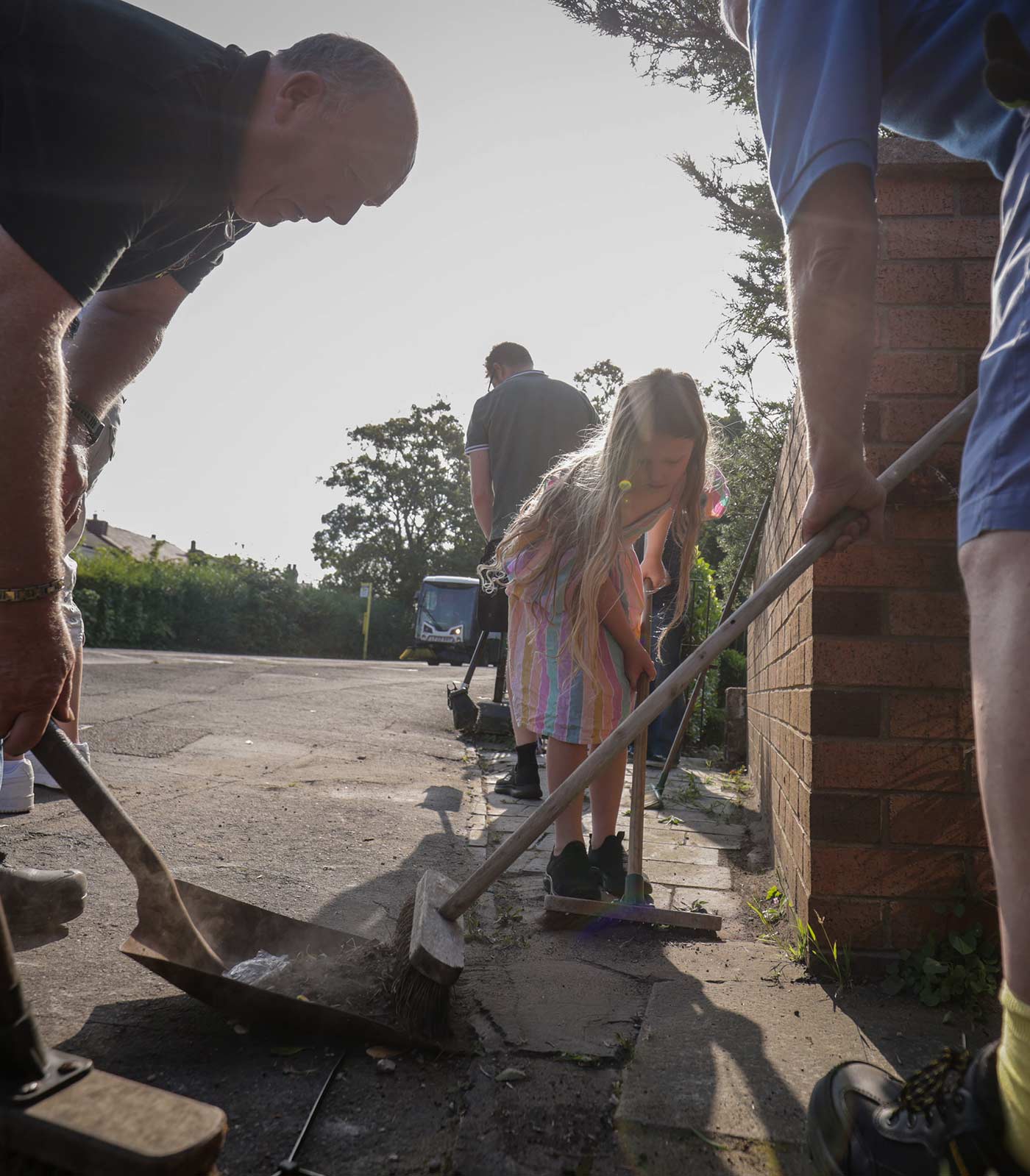 Locals help sweep Sussex Road in Southport the morning after riots in the area - 31 July 2024