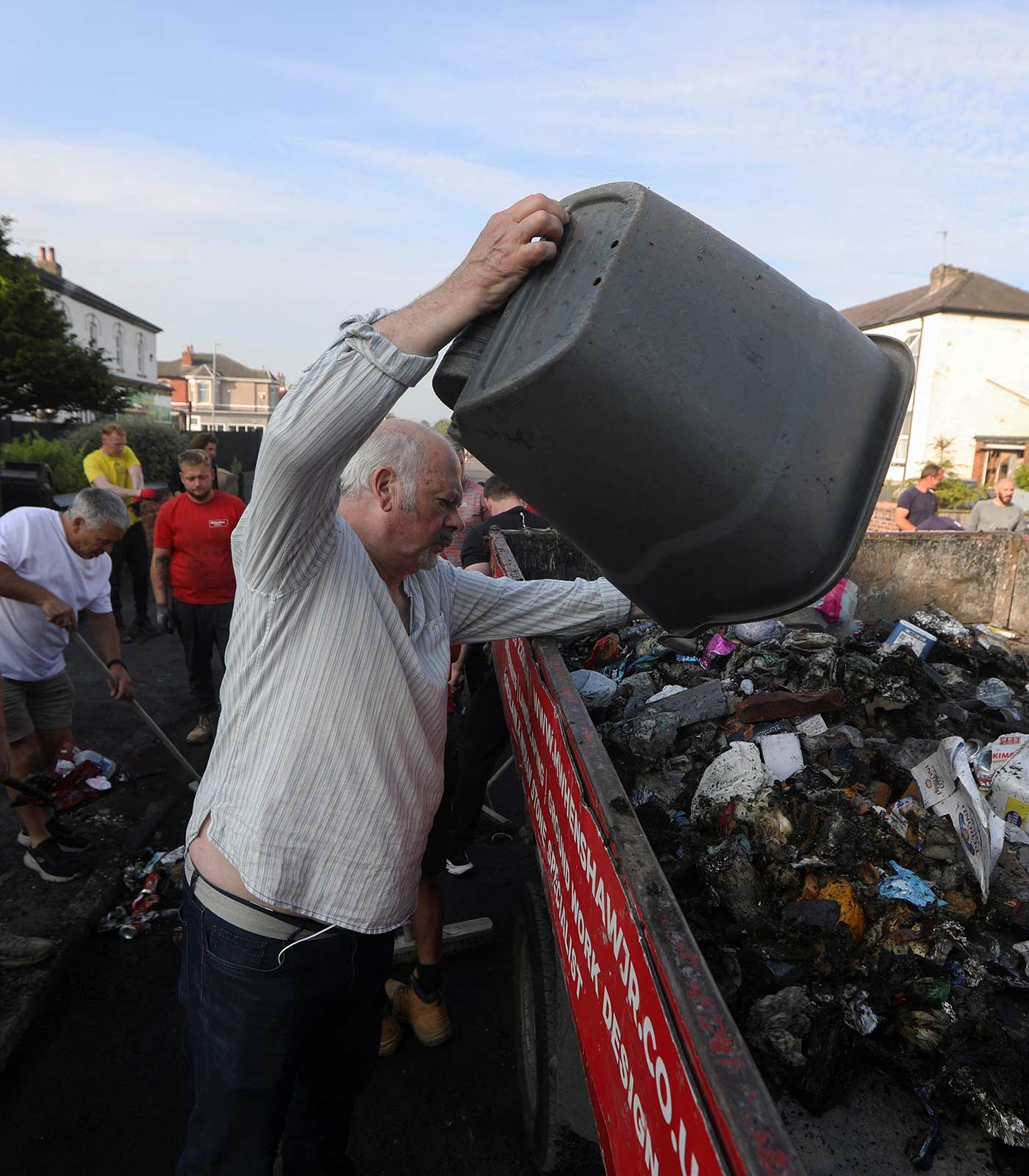 Volunteers clean Sussex Road the morning after riots in Southport - 31 July 2024