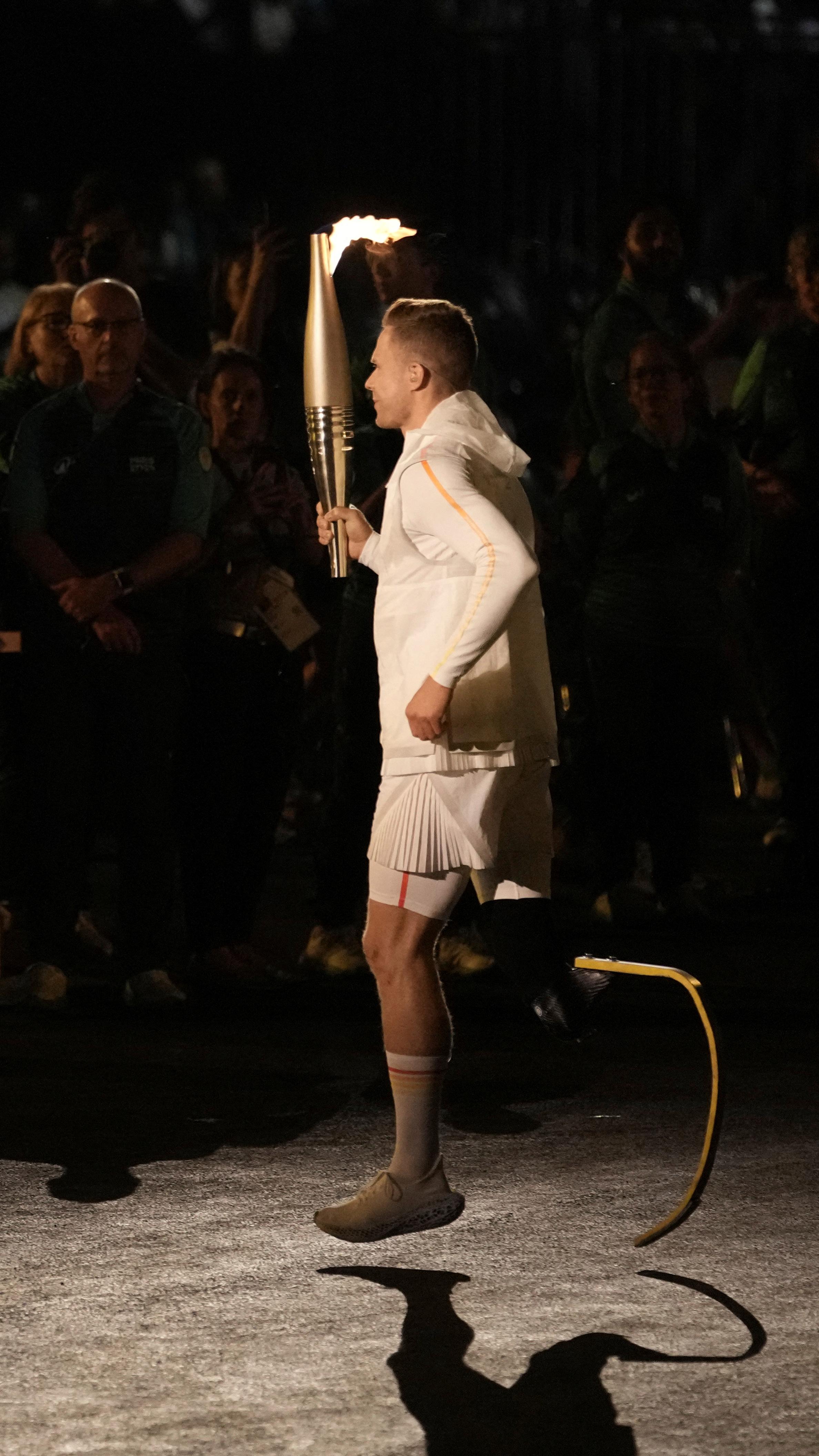 Markus Rehm carries the torch during the opening ceremony in Paris  - 28 August 2024