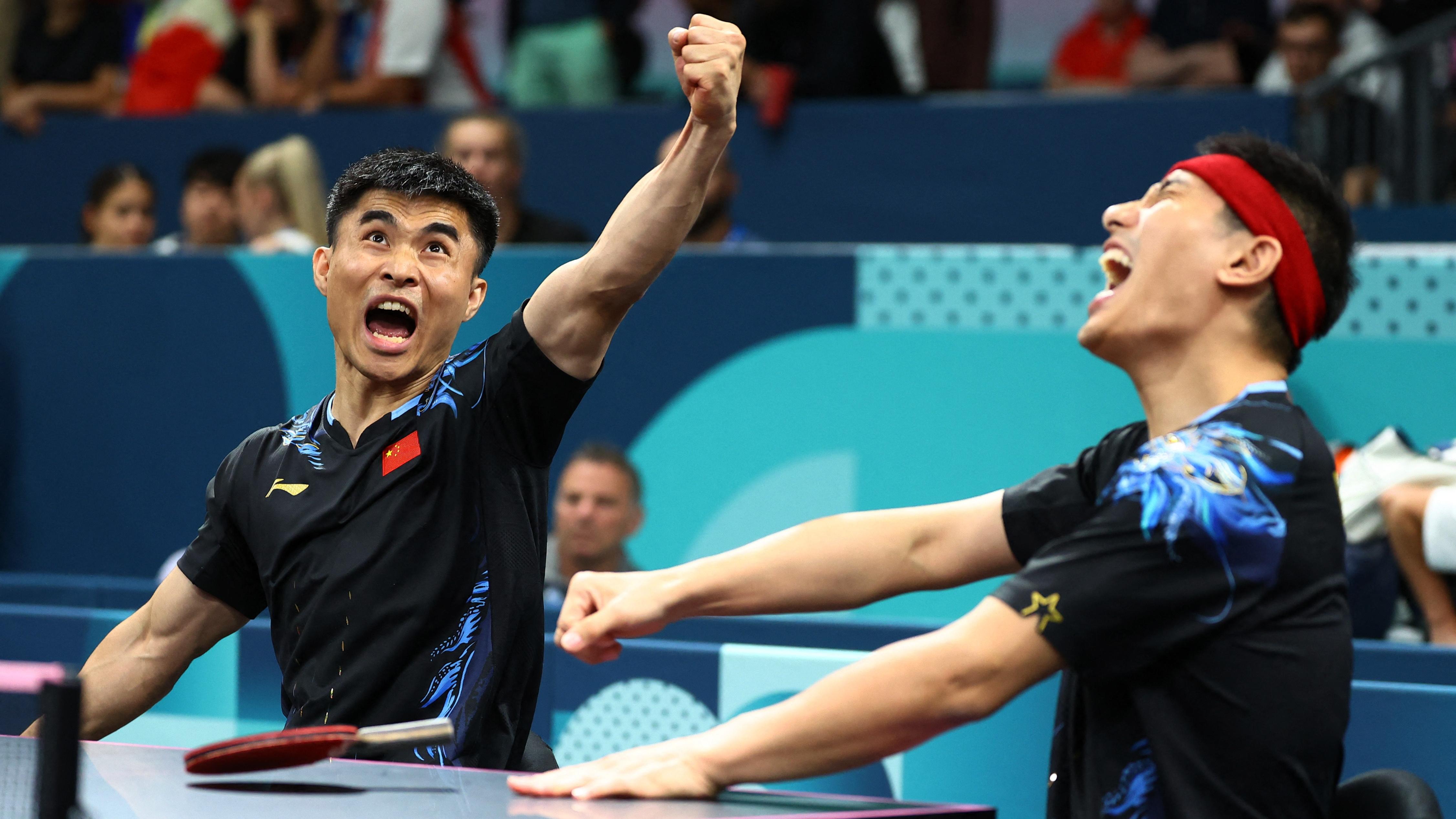 Ningning Cao and Panfeng Feng of China react during their table tennis match in the Paris Paralympic Games 2024