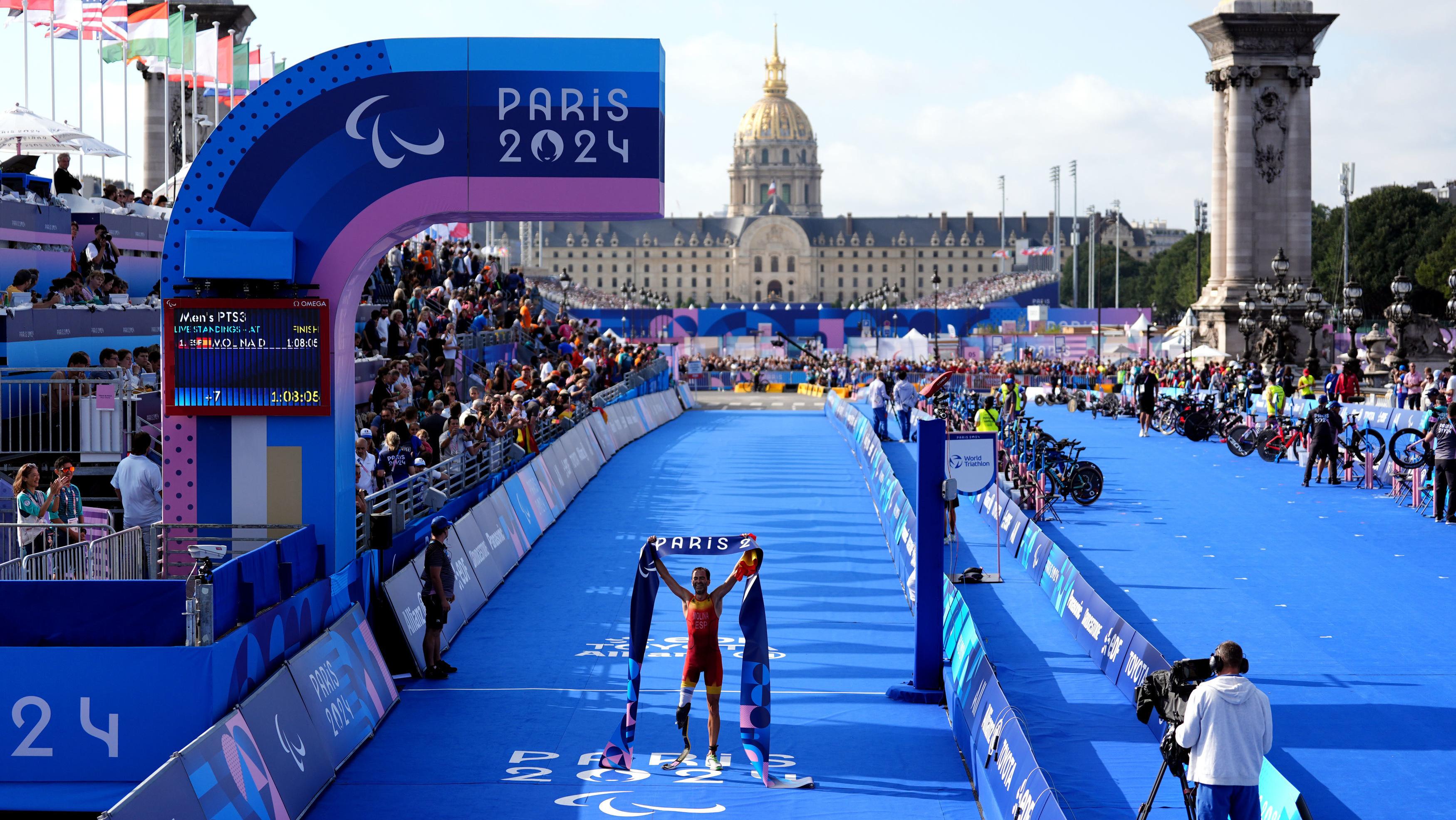 Spaniard Daniel Molina crosses the finish line to win the men's PTS3 Para-Triathlon at the Pont Alexandre III at the 2024 Summer Paralympics in Paris