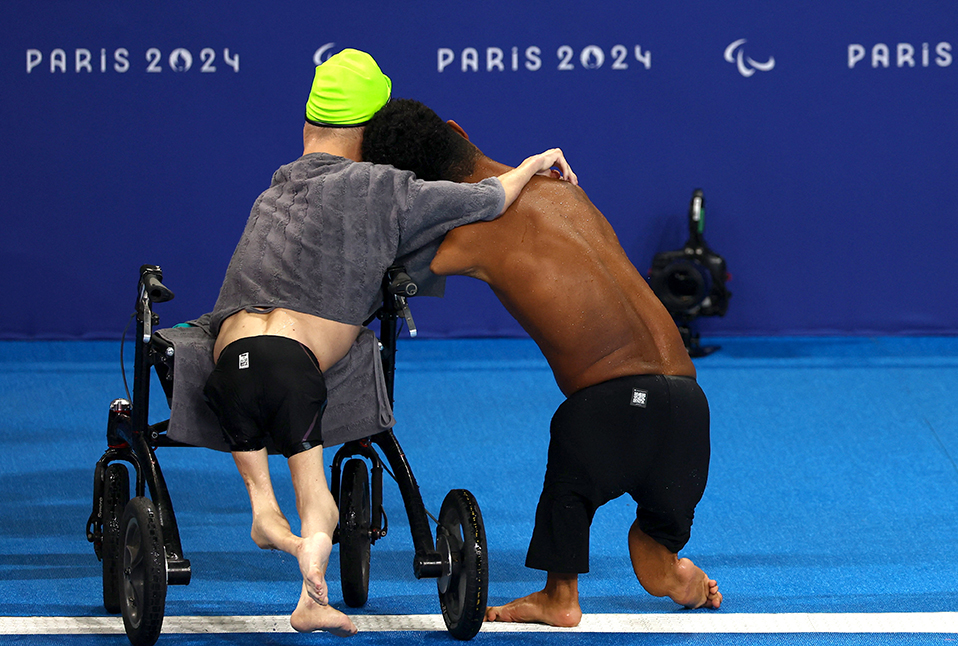 Gabriel Geraldo of Brazil celebrates with a fellow athlete his victory in the swimming competition at the Paris 2024 Paralympic Games