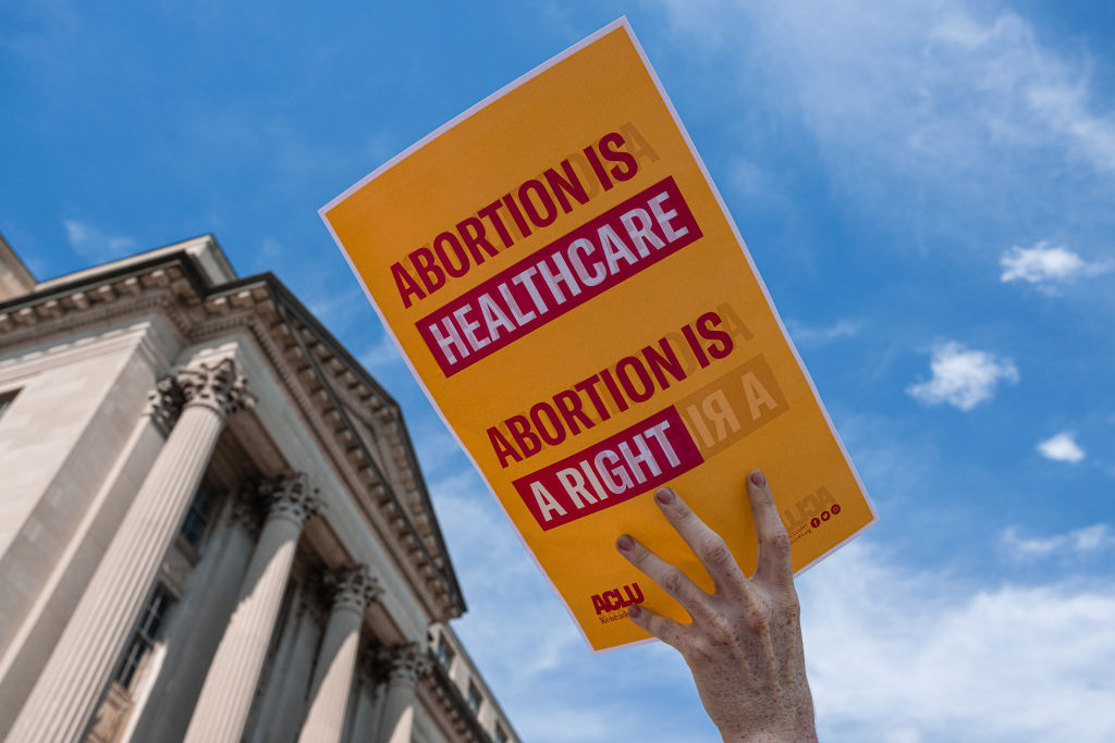 An abortion rights protester displays a sign outside during a gathering outside of The Gene Snyder U.S. Courthouse in response to the U.S. Supreme Courts conservative majority decision to overturn Roe v. Wade and ending constitutional protections for abortion on June 24, 2022 in Louisville, United States.