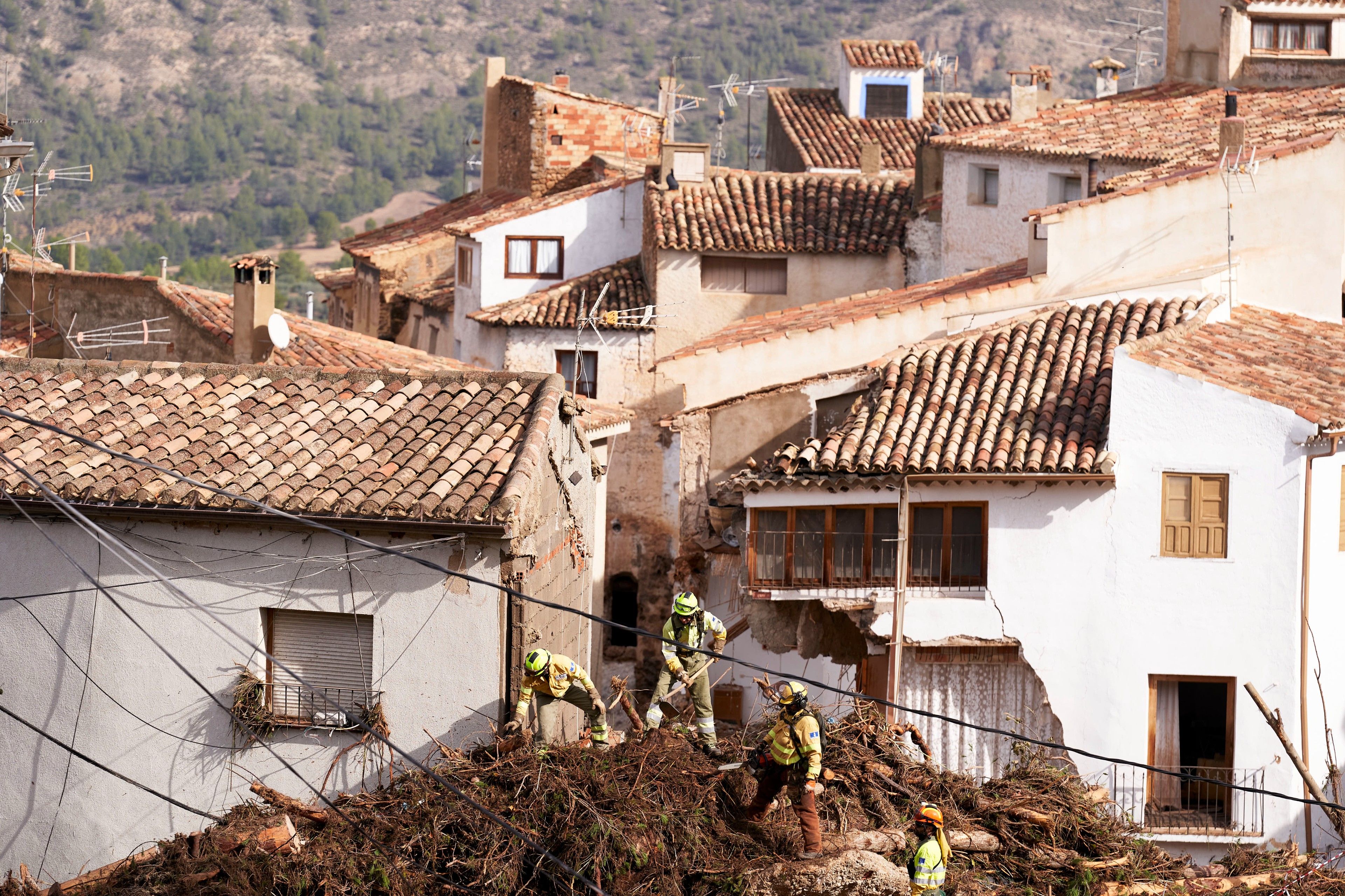 Emergency workers clear debris after heavy rains hit the region on October 30, 2024 in Letur, Albacete province, Spain