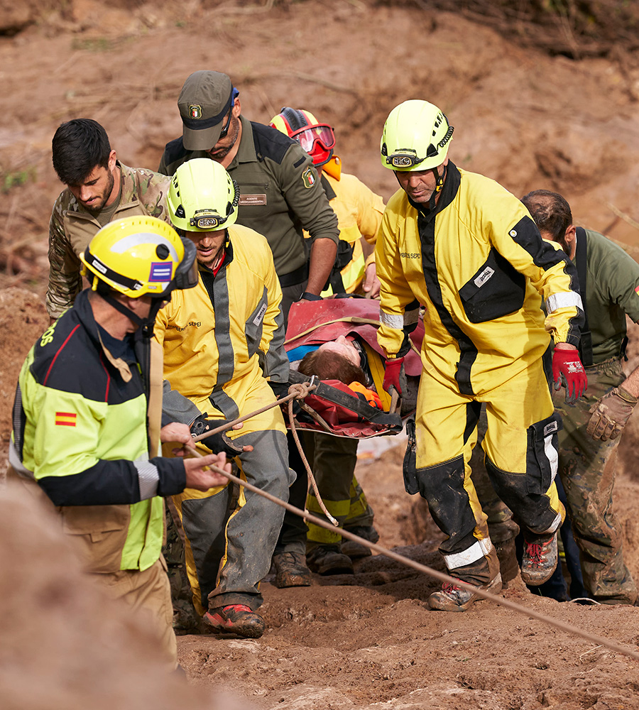 Emergency workers carry an injured person after flash floods hit the region on October 30, 2024 in Letur, Albacete province, Spain. 