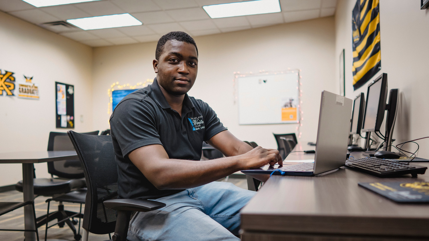 Arthur Beauford uses a computer in a room with university memorabilia in Marietta, Georgia.