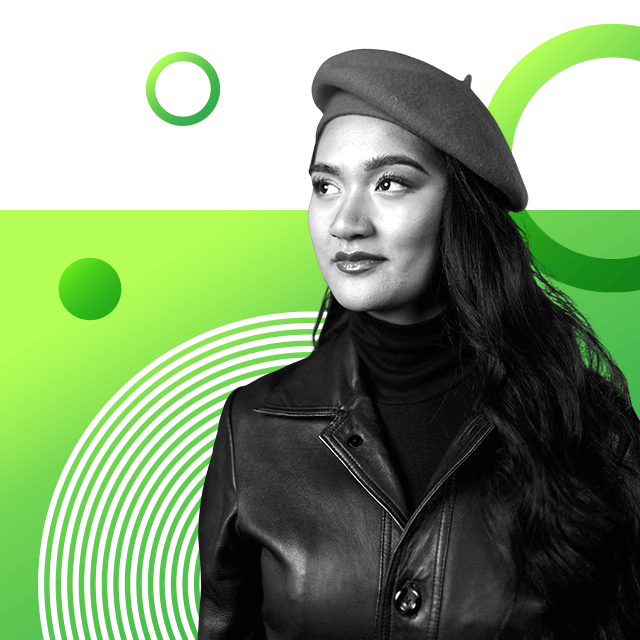 Politician Hana-Rawhiti Maipi-Clarke looking off camera with long hair wearing a French beret, polar neck top and leather jacket over it.