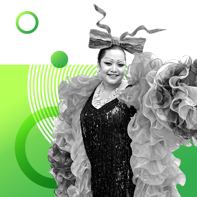 LGBTQ+ rights campaigner Ann Chumaporn (Waaddao) wearing a large bow-shaped headband, sparkling dress along with a sparkly necklace and a huge ruffle coat.