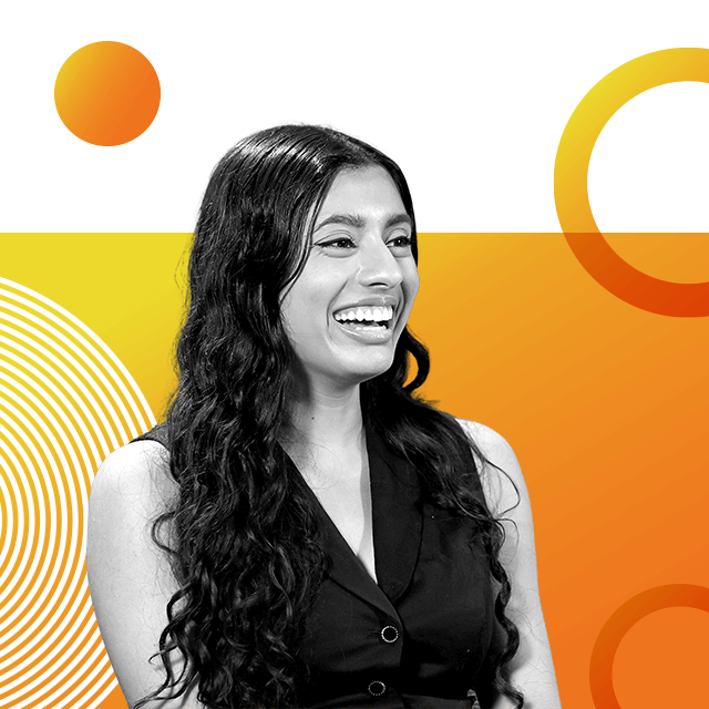 AI expert Sneha Revanur with long black curly hair, smiling and looking off camera in a sleeveless waistcoat.