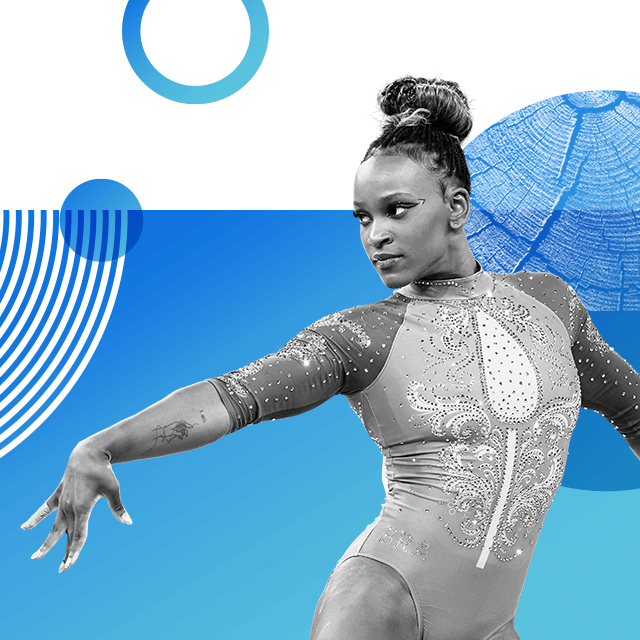 Gymnast Rebecca Andrade stands in a competition pose with her hand outstretched wearing a shiny gym leotard decorated with rhinestones. Her hair is worn in a tight bun and her eyes are adorned with winged eyeliner.