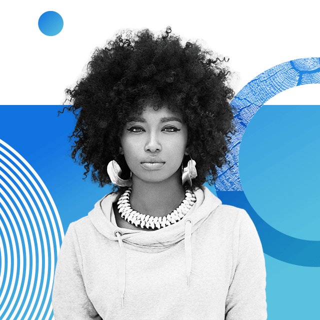 Climate activist and singer Inna Modja wearing a pale drawstring hoodie, large hoop earrings, winged eyeliner and a large woven necklace. Her hair is styled in an afro.