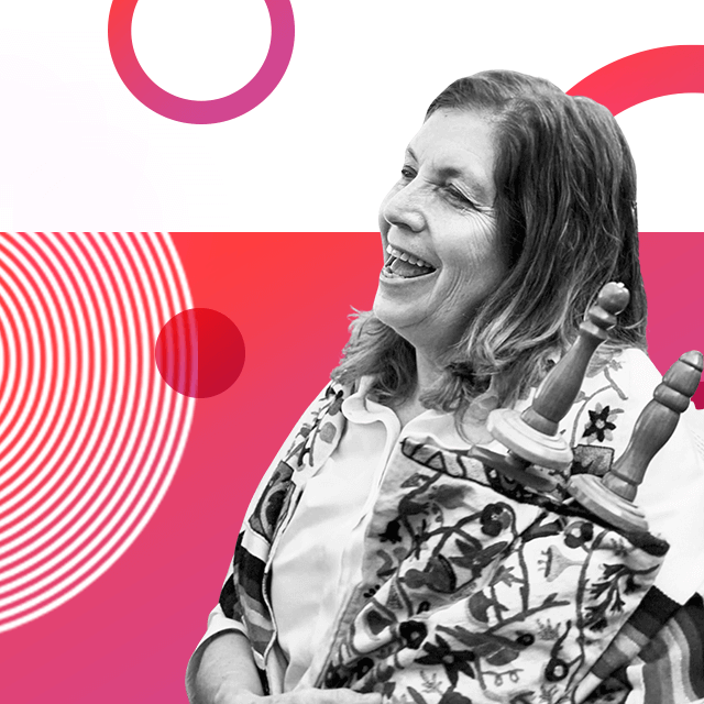 Israeli religious campaigner Anat Hoffman smiling with her mouth open and pictured wearing embroidered floral prayer shawl.