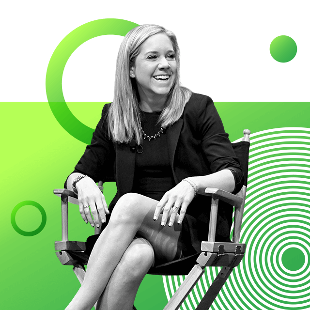 Advocate Amanda Zurawski with medium-length hair sitting on a folding chair, smiling broadly and wearing a dark skirt and jacket suit.