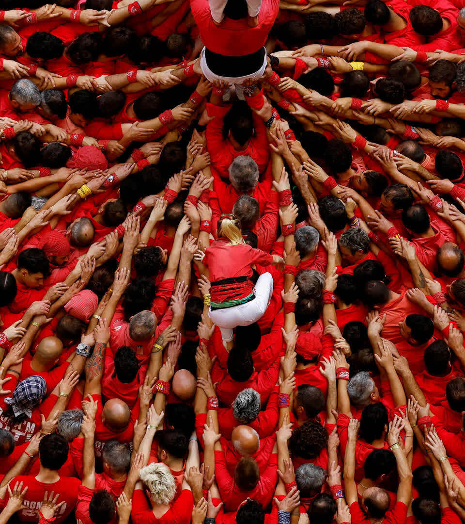 Group members of Colla Joves Xiquets de Valls start to form a human tower in Tarragona, Spain, 6 October 2024.