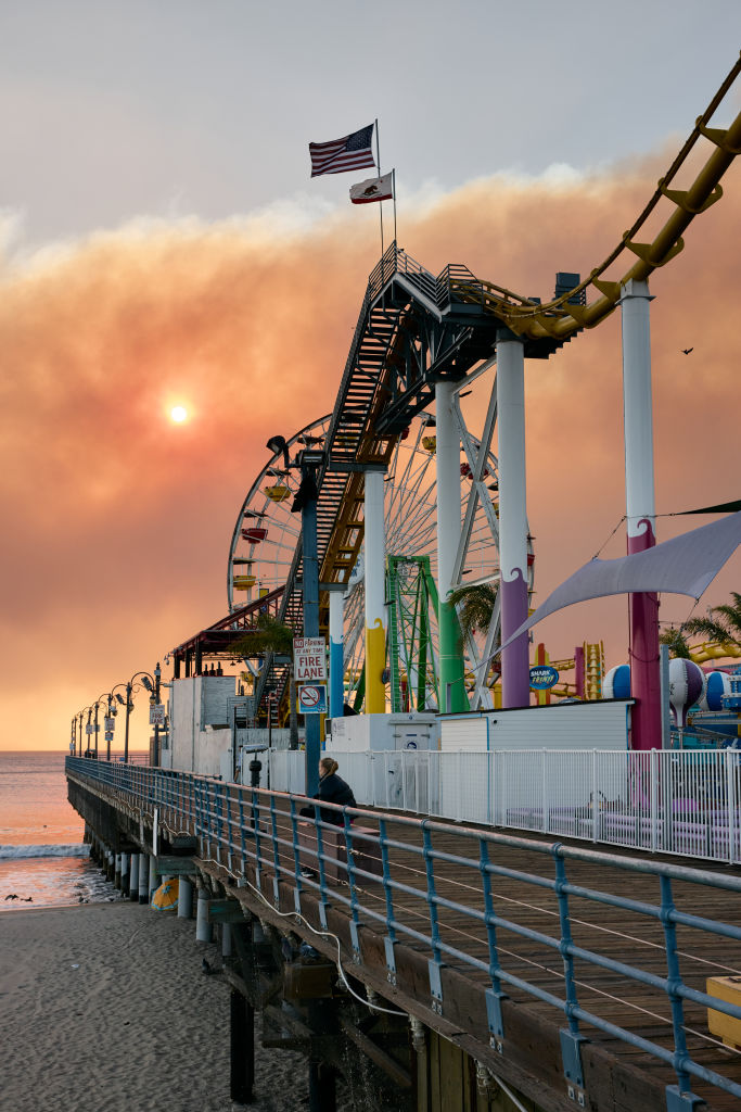 Santa Monica Pier with smoke from the Palisades fire in the distance