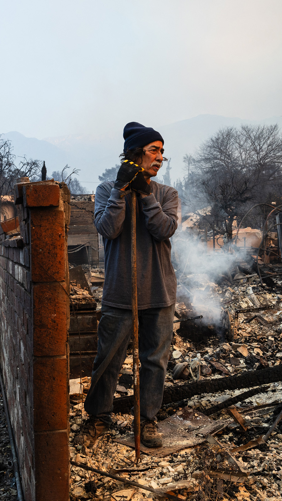 Residents looks at the ruins of a home destroyed by the Eaton Fire in Altadena