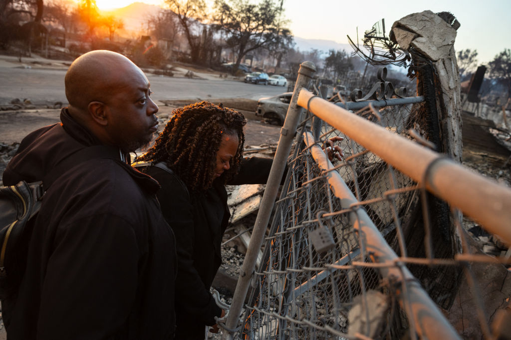 A couple looks at the charred remains of their home burned in the Eaton Fire in Altadena, California, January 9, 2025